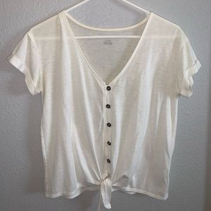 White button-down shirt with a tie at the bottom